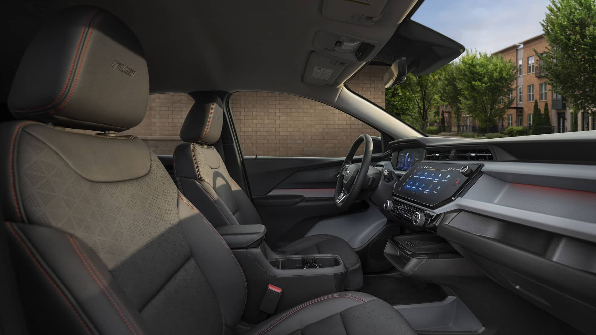 Modern car interior with black seats, red stitching, digital dashboard, and touchscreen display.
