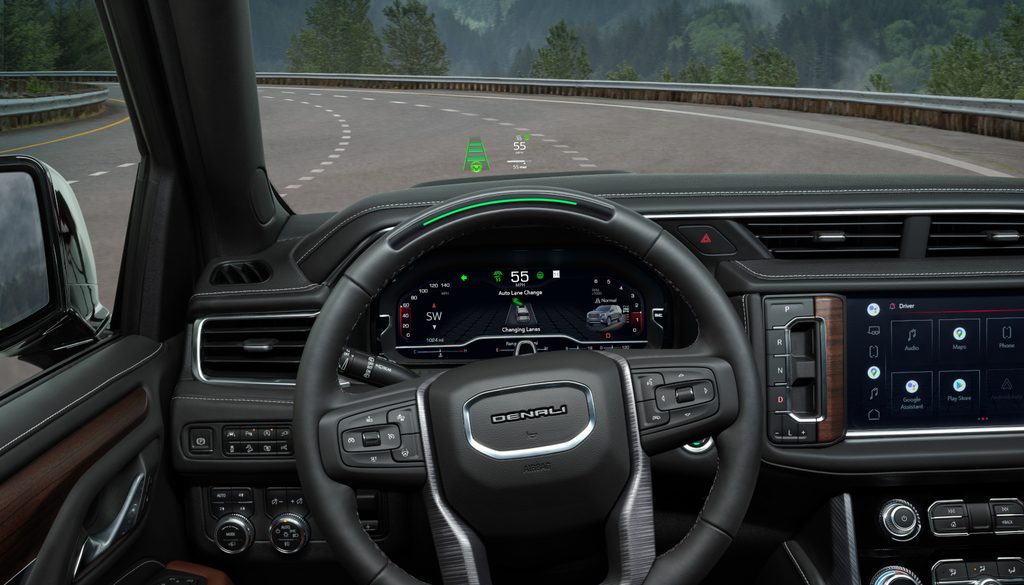 Car dashboard with digital display, steering wheel, and touchscreen showing navigation and controls.